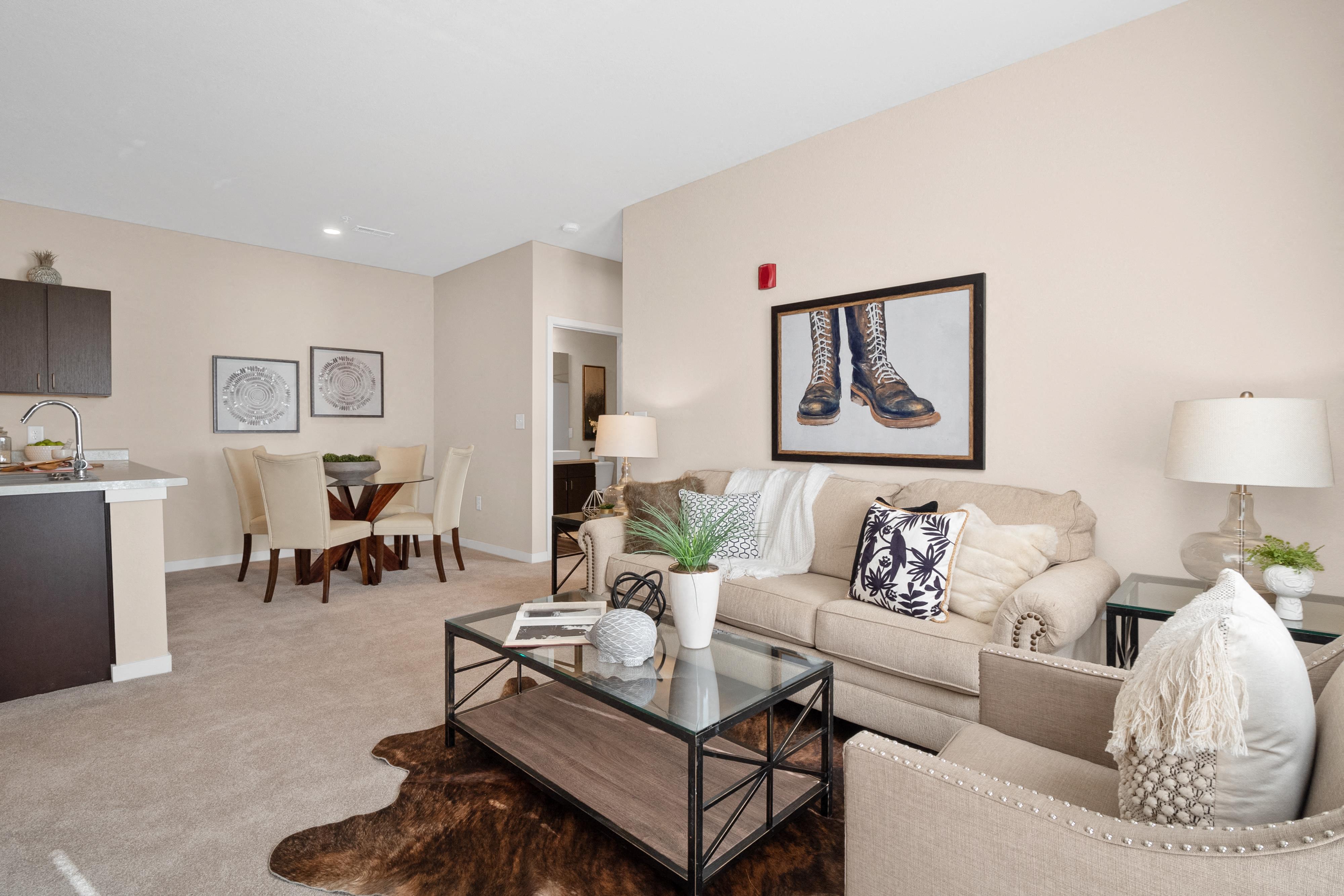 a living room with a couch and a coffee table  at Aventura at Wentzville, Wentzville
